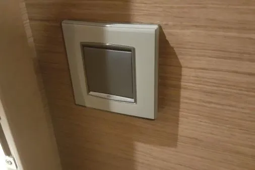 Lone Star Lagoon Yacht Photos Pics Light switch on wooden wall inside 2019 Lagoon 50 yacht.