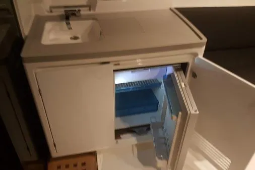 Lone Star Lagoon Yacht Photos Pics 2019 Lagoon 50 yacht kitchenette with sink and open mini fridge.