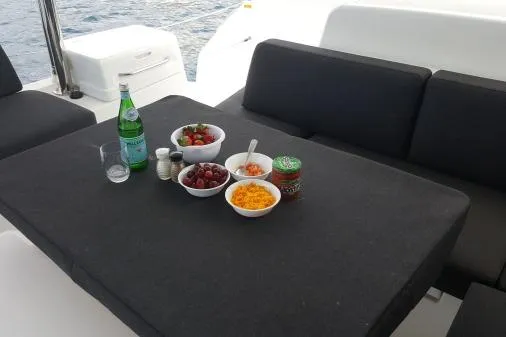 Lone Star Lagoon Yacht Photos Pics Outdoor dining setup on Lagoon 50 yacht with snacks and drinks, 2019 model.