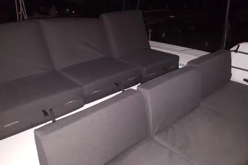 Lone Star Lagoon Yacht Photos Pics 2019 Lagoon 50 yacht with dark cushioned seating in dim lighting.