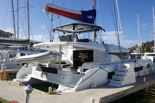 Lone Star Lagoon Yacht Photos Pics 2019 Lagoon 50 catamaran docked at marina, featuring spacious deck and modern design.