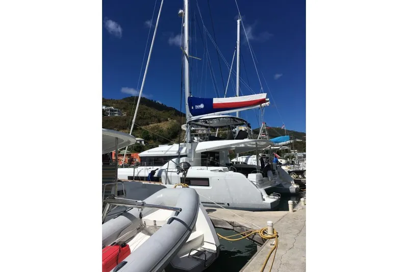 Lone Star Lagoon Yacht Photos Pics 2019 Lagoon 50 catamaran docked at marina under clear blue sky.