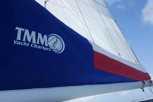 Lone Star Lagoon Yacht Photos Pics Sail of 2019 Lagoon 50 yacht with TMM Yacht Charters branding against blue sky.