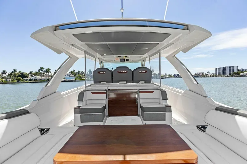 Luna B Yacht Photos Pics 2018 Tiara Yachts 38 LS luxury boat interior with seating and table, on calm water.