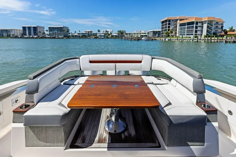 Luna B Yacht Photos Pics Luxurious seating area on 2018 Tiara Yachts 38 LS, overlooking waterfront buildings.