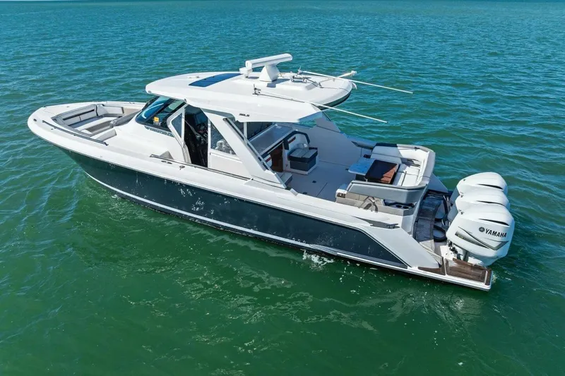 Luna B Yacht Photos Pics 2018 Tiara Yachts 38 LS cruising on clear blue water, featuring triple Yamaha engines.