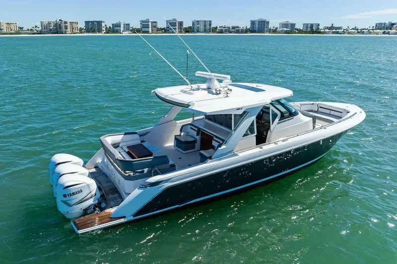 Luna B Yacht Photos Pics 2018 Tiara Yachts 38 LS boat on water with city skyline in background.