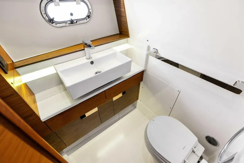 Luna B Yacht Photos Pics Luxurious bathroom interior of 2018 Tiara Yachts 38 LS with modern sink and toilet.