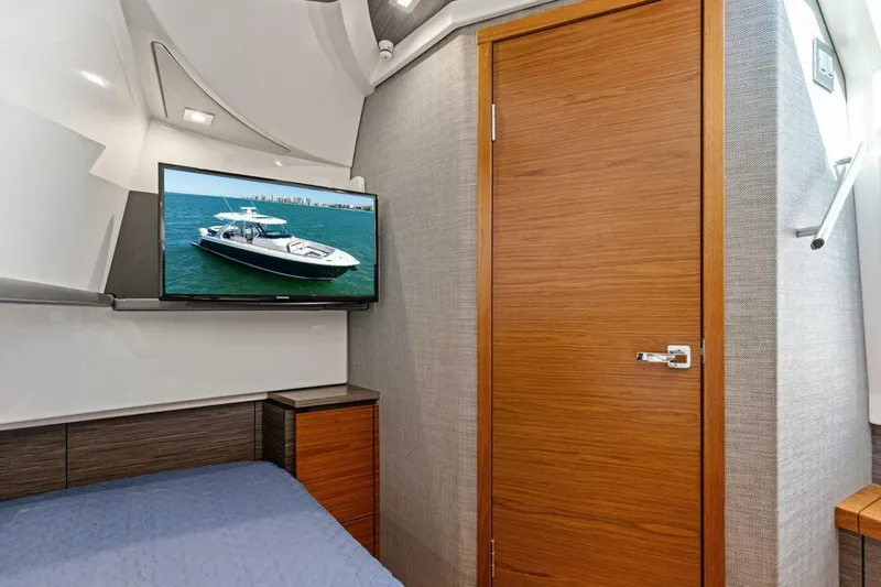Luna B Yacht Photos Pics Interior cabin of 2018 Tiara Yachts 38 LS with TV and wooden door.