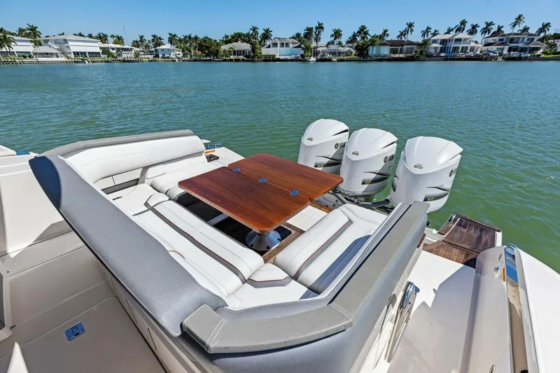 Luna B Yacht Photos Pics 2018 Tiara Yachts 38 LS with seating area and triple Yamaha engines on a sunny day.