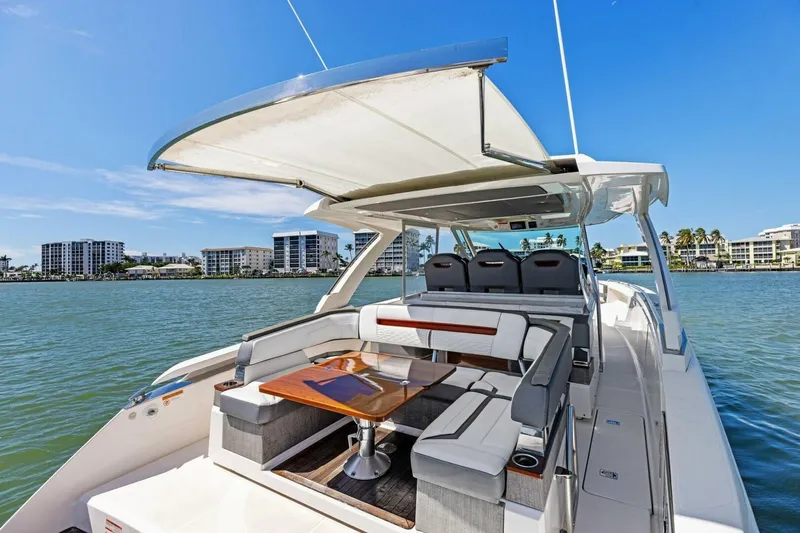 Luna B Yacht Photos Pics 2018 Tiara Yachts 38 LS with spacious seating and canopy on calm waters.