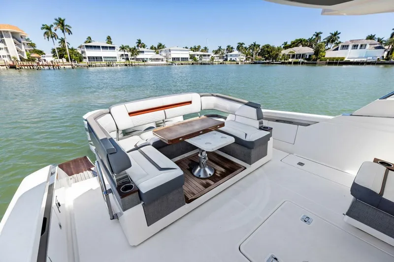 Luna B Yacht Photos Pics Luxurious seating area on 2018 Tiara Yachts 38 LS, overlooking serene waterfront homes.