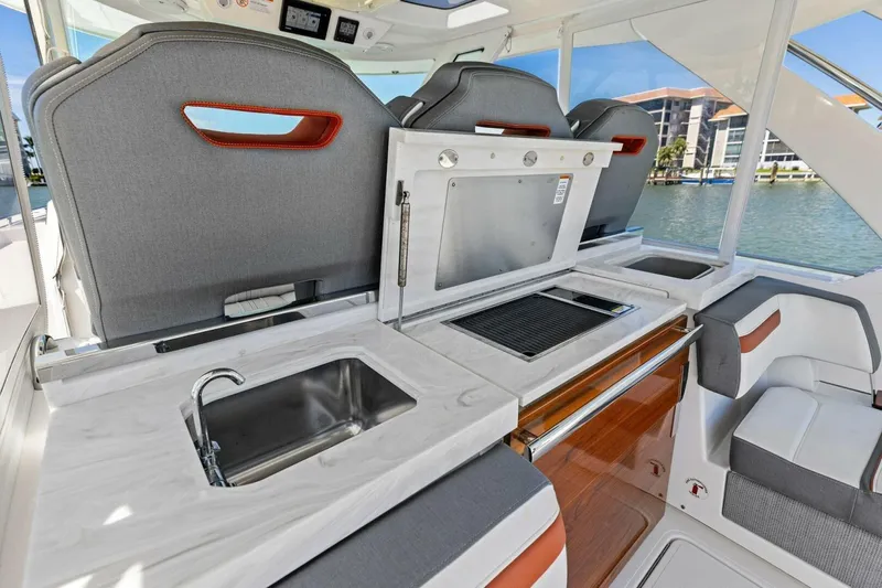 Luna B Yacht Photos Pics 2018 Tiara Yachts 38 LS interior with sleek kitchen and seating area.