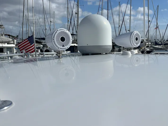 P A N D E M I C Yacht Photos Pics Rooftop of 2010 Intrepid 43 Sport Yacht with radar and speakers, docked in marina.