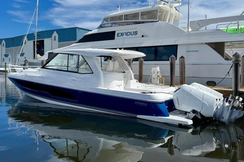  Yacht Photos Pics 2026 Intrepid 50 boat docked, featuring sleek design and powerful outboard engines.