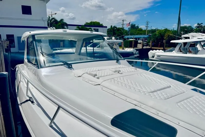  Yacht Photos Pics 2026 Intrepid 50 yacht docked at marina under clear blue sky.