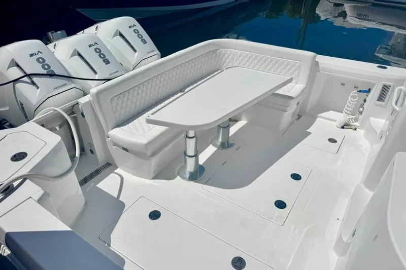  Yacht Photos Pics Luxurious seating area on 2026 Intrepid 50 boat with modern outboard engines.