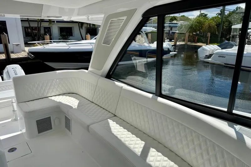  Yacht Photos Pics Luxurious interior of 2026 Intrepid 50 yacht with white quilted seating.