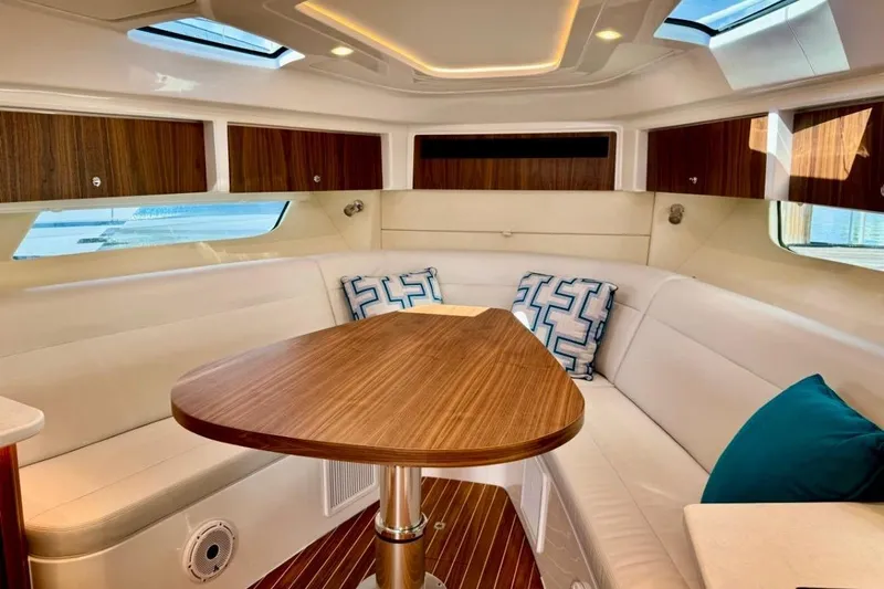  Yacht Photos Pics Luxurious interior of 2026 Intrepid 50 yacht with elegant wood finishes and plush seating.