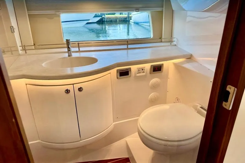  Yacht Photos Pics Luxurious bathroom interior of 2026 Intrepid 50 yacht with modern fixtures and scenic window view.