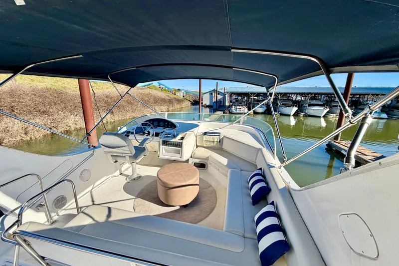  Yacht Photos Pics 2002 Bayliner 3988 Command Bridge Motoryacht interior with helm, seating, and marina view.