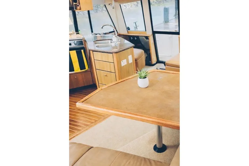  Yacht Photos Pics Interior of 2002 Bayliner 3988 Command Bridge Motoryacht with kitchen and dining area.