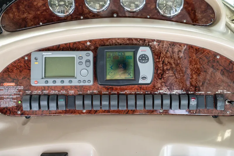 Murphys Law Yacht Photos Pics Control panel of a 2004 Sea Ray 380 Sundancer with navigation and system switches.