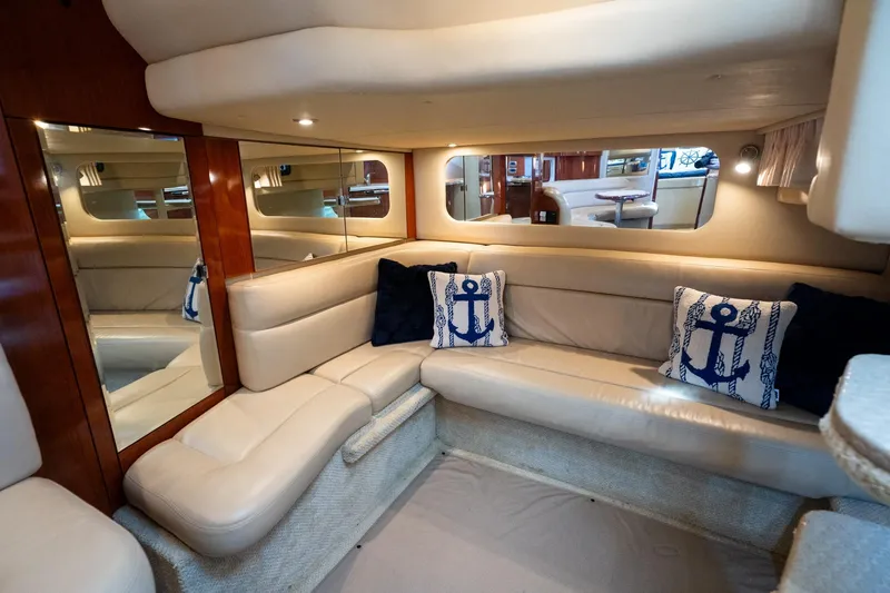 Murphys Law Yacht Photos Pics Luxurious 2004 Sea Ray 380 Sundancer interior with beige seating and nautical-themed pillows.