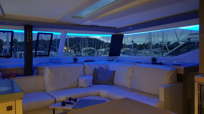 Super Trouper Yacht Photos Pics Luxurious interior of 2019 Fountaine Pajot Saona 47 yacht with ambient blue lighting.