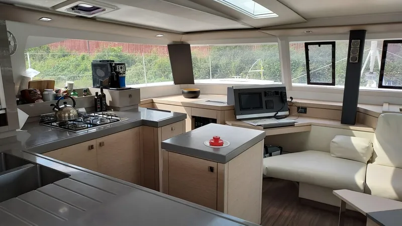 Super Trouper Yacht Photos Pics Luxurious interior of 2019 Fountaine Pajot Saona 47 catamaran with modern kitchen and seating area.