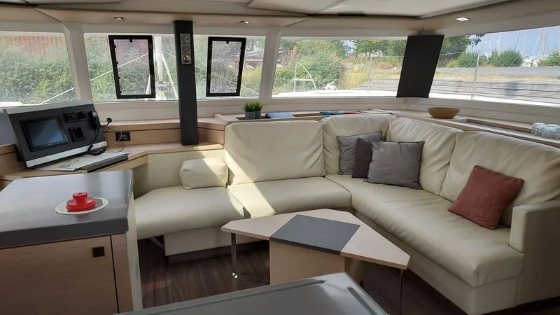 Super Trouper Yacht Photos Pics Luxurious interior of 2019 Fountaine Pajot Saona 47 catamaran with plush seating and modern design.