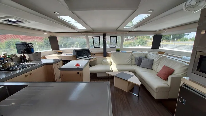 Super Trouper Yacht Photos Pics Luxurious interior of 2019 Fountaine Pajot Saona 47 catamaran with modern kitchen and seating area.