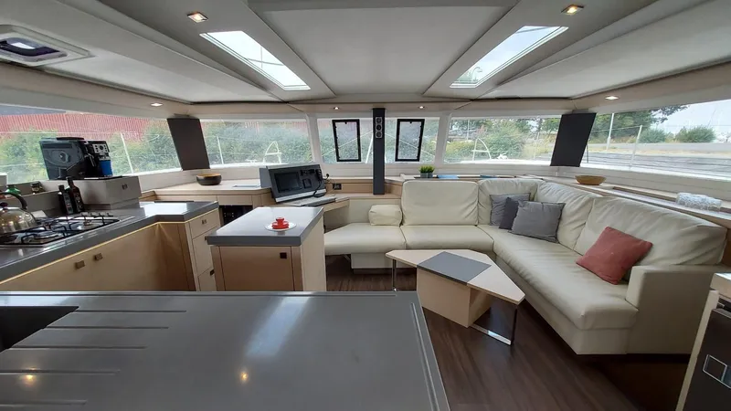 Super Trouper Yacht Photos Pics Luxurious interior of 2019 Fountaine Pajot Saona 47 catamaran with modern kitchen and seating area.