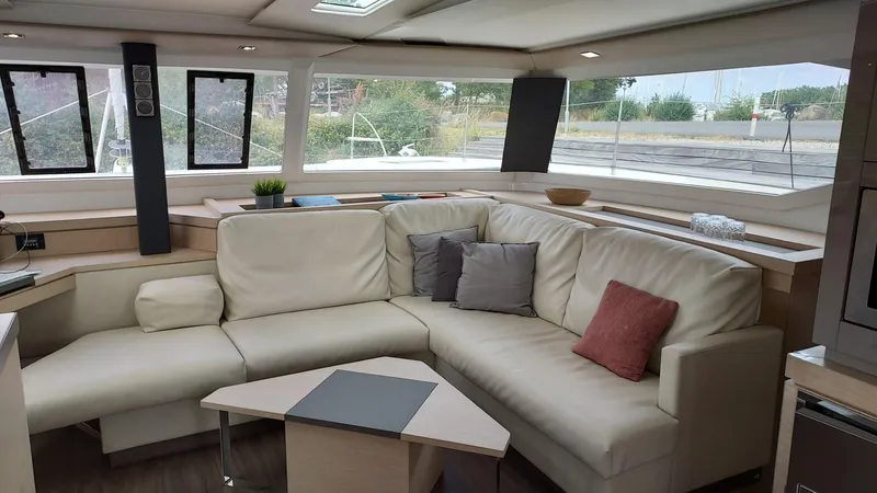 Super Trouper Yacht Photos Pics Luxurious interior of 2019 Fountaine Pajot Saona 47 catamaran with modern seating and panoramic windows.