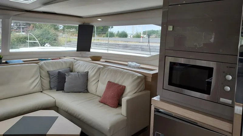 Super Trouper Yacht Photos Pics Luxurious interior of 2019 Fountaine Pajot Saona 47 catamaran with modern kitchen and comfortable seating.