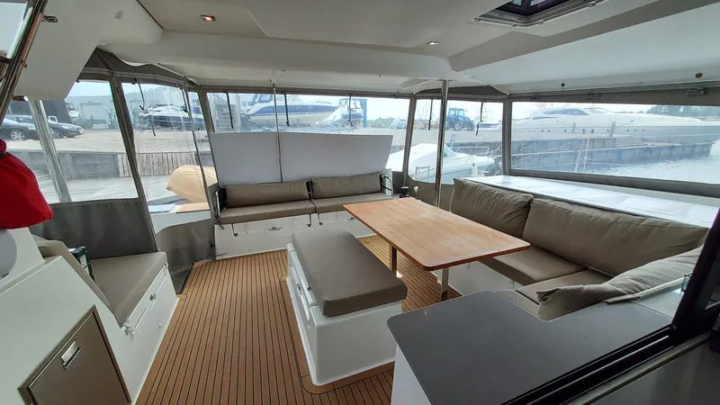 Super Trouper Yacht Photos Pics 2019 Fountaine Pajot Saona 47 yacht interior with spacious seating and wooden table.