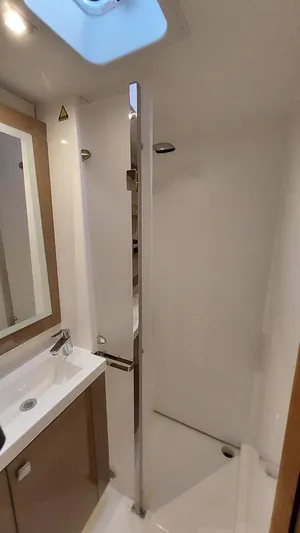 Super Trouper Yacht Photos Pics Bathroom interior of 2019 Fountaine Pajot Saona 47 catamaran, featuring modern fixtures and skylight.