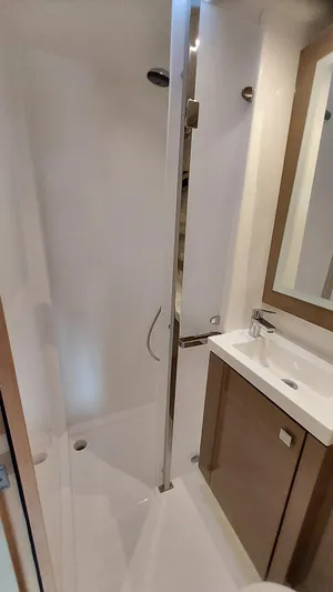 Super Trouper Yacht Photos Pics Bathroom interior of 2019 Fountaine Pajot Saona 47 catamaran, featuring modern shower and sink.