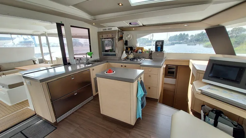 Super Trouper Yacht Photos Pics Modern kitchen interior of 2019 Fountaine Pajot Saona 47 catamaran with sleek design and appliances.