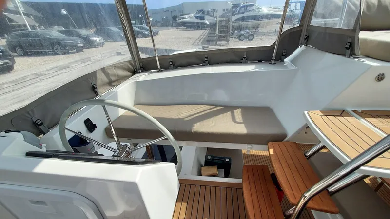 Super Trouper Yacht Photos Pics 2019 Fountaine Pajot Saona 47 yacht cockpit with steering wheel and wooden steps.