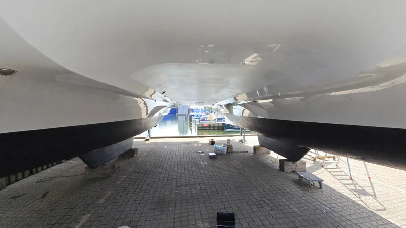 Super Trouper Yacht Photos Pics 2019 Fountaine Pajot Saona 47 catamaran hulls on dry dock, showcasing sleek design and structure.