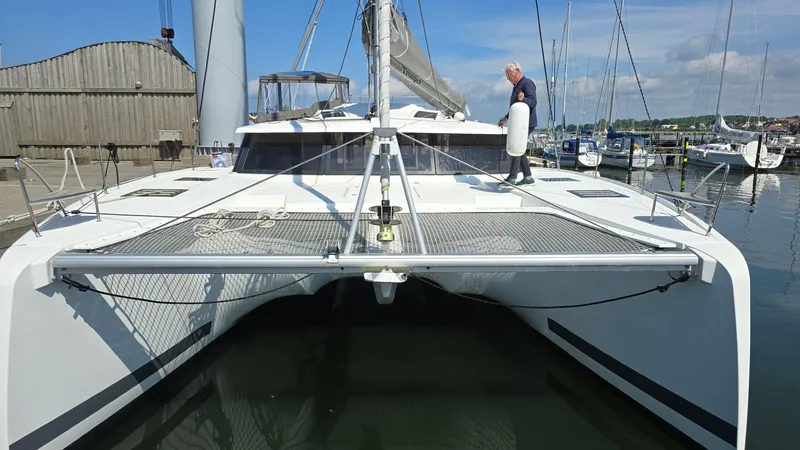 Super Trouper Yacht Photos Pics 2019 Fountaine Pajot Saona 47 catamaran docked at marina, with person on deck.