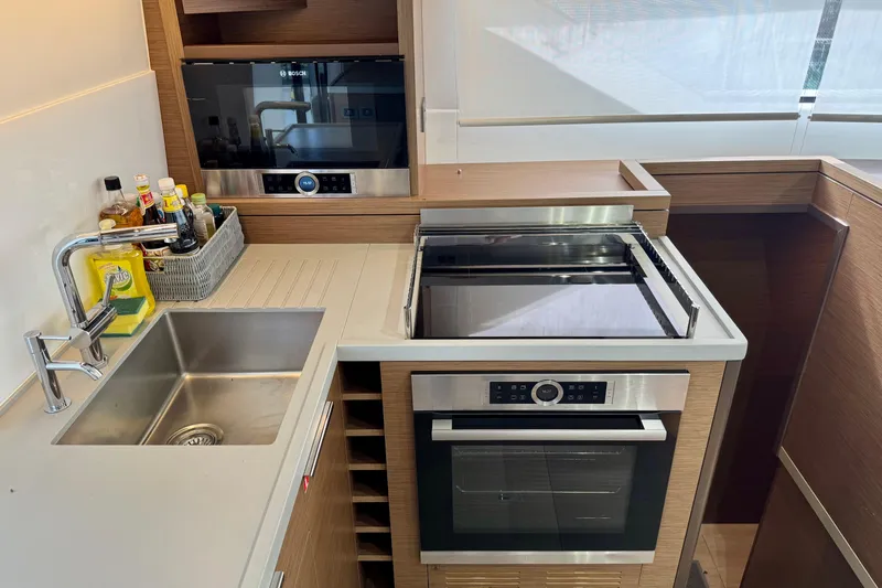 Promprang Yacht Photos Pics Modern kitchen in a 2020 Lagoon 50 yacht with stainless steel appliances.