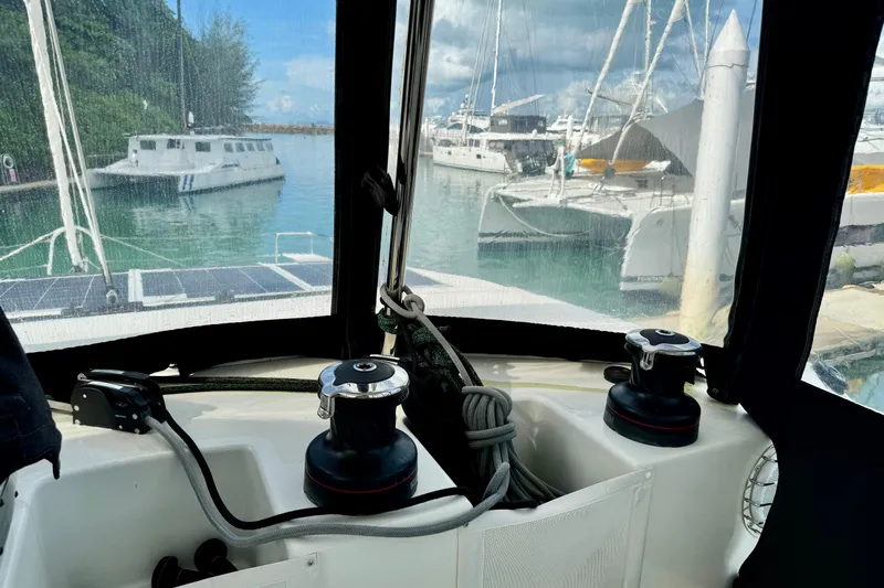 Promprang Yacht Photos Pics Cockpit view of 2020 Lagoon 50 catamaran docked in a marina with other boats.