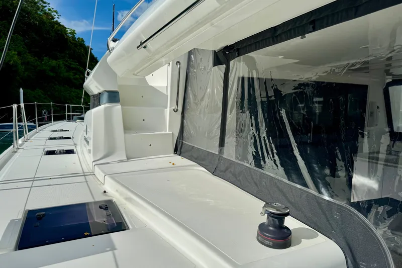 Promprang Yacht Photos Pics 2020 Lagoon 50 yacht deck with clear canopy and lush greenery in the background.