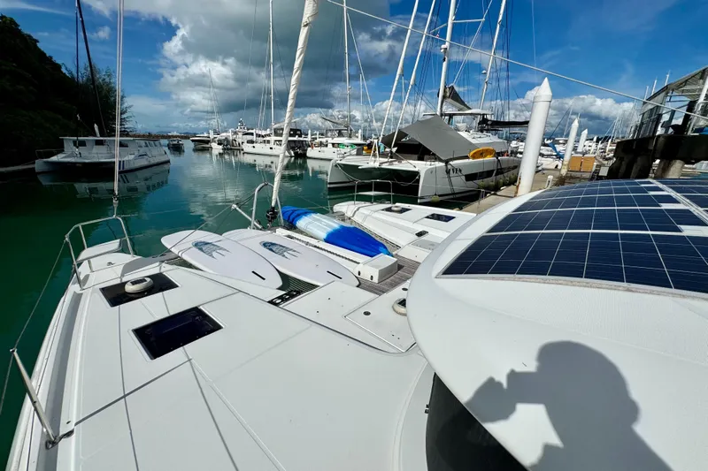 Promprang Yacht Photos Pics 2020 Lagoon 50 catamaran docked at marina with solar panels and paddleboards.