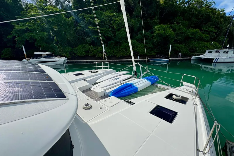 Promprang Yacht Photos Pics Lagoon 50 catamaran (2020) with solar panels docked in a serene marina setting.