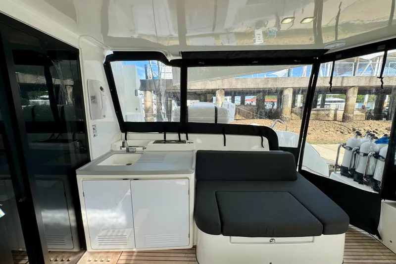 Promprang Yacht Photos Pics Interior of 2020 Lagoon 50 yacht with seating and kitchenette area.