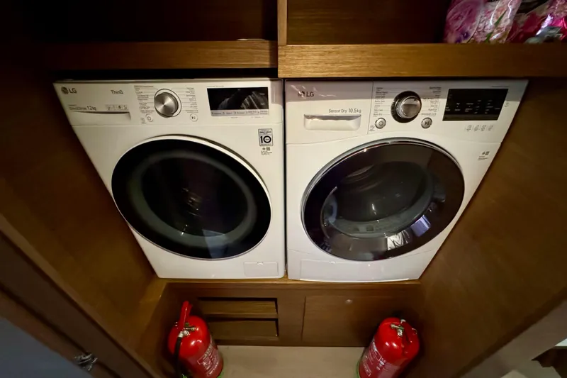 Promprang Yacht Photos Pics Laundry area on Lagoon 50 yacht with LG washer and dryer, fire extinguishers visible.