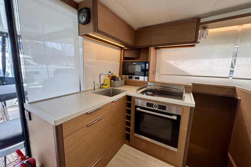 Promprang Yacht Photos Pics Modern kitchen in 2020 Lagoon 50 yacht with sleek wood cabinetry and stainless steel appliances.